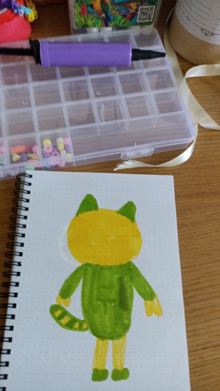 Alice's first green and yellow lion drawing in a notebook